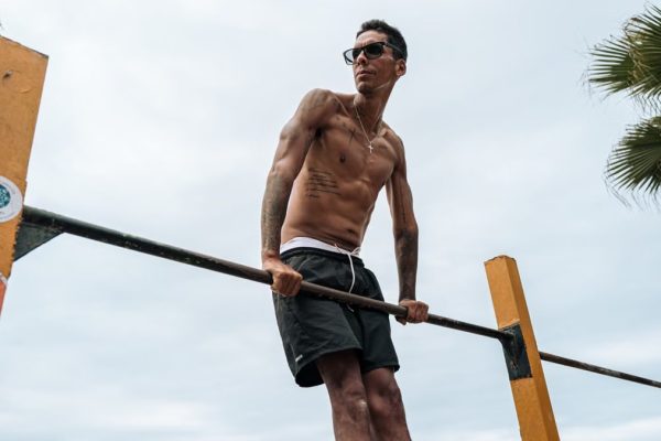 Athletic man practicing calisthenics on a sunny day in Trujillo, Peru.